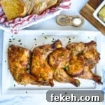 Fresh Chicken Recipes for Summer Grilling and Light Meals 12 Platter of cooked chicken quarters on a white plate sprinkled with parsley flakes.