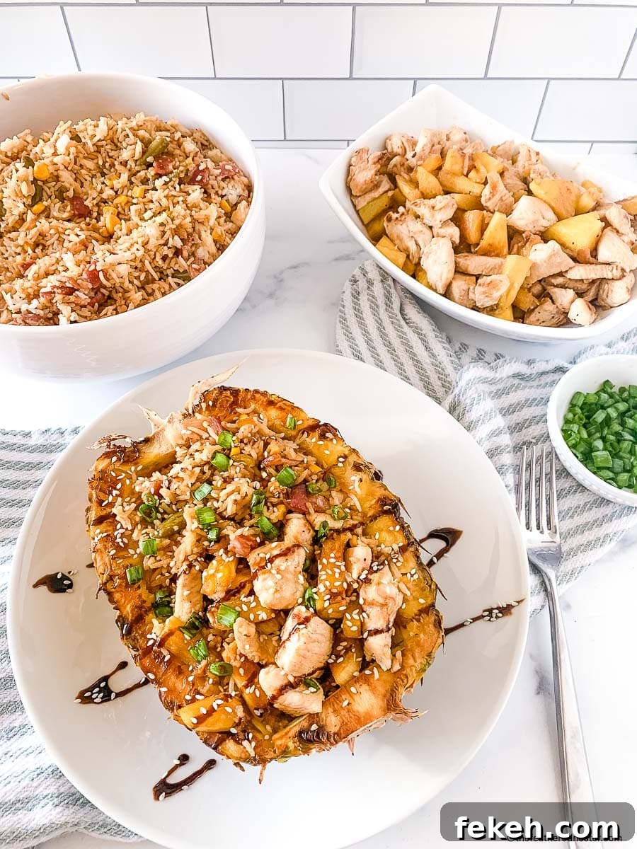 Fresh Chicken Recipes for Summer Grilling and Light Meals 3 chicken teriyaki pineapple bowl with teriyaki glaze placed on a white plate with cloth, pineapple chicken, fried rice, and onion chives all placed in a bowl at the background.