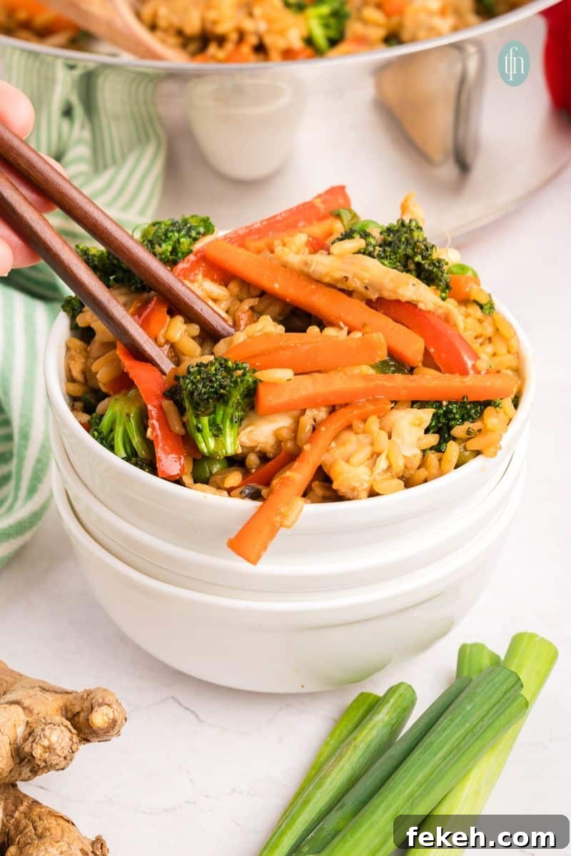 Fresh Chicken Recipes for Summer Grilling and Light Meals 5 A bowl of fried rice with veggies and chicken.