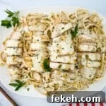 Fresh Chicken Recipes for Summer Grilling and Light Meals 9 Garlic parmesan chicken pasta on a white serving plate.