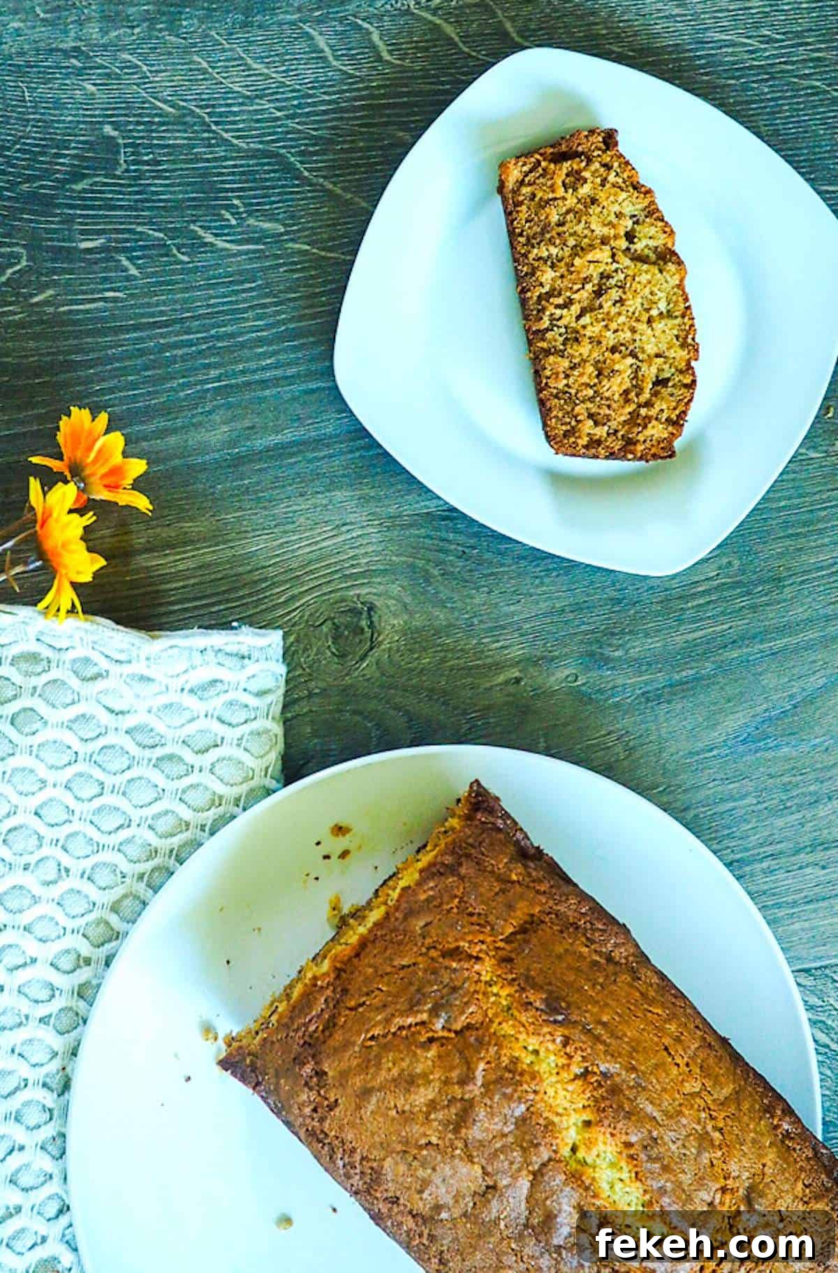 Banana Bread Made in a Bread Machine: Simple Step-by-Step Recipe 5 A loaf of bread machine banana bread on a white plate with a slice on a smaller white plate.