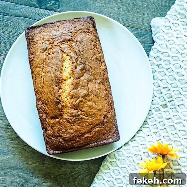 Banana Bread Made in a Bread Machine: Simple Step-by-Step Recipe 6 A loaf of bread machine banana bread on a white plate.