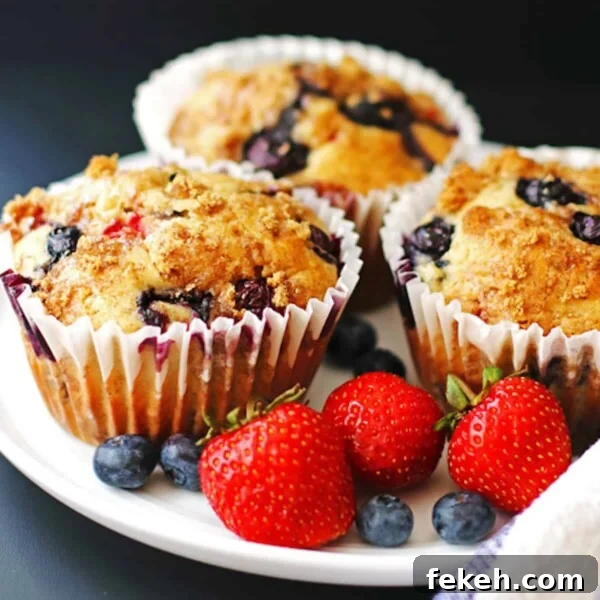 Banana Bread Made in a Bread Machine: Simple Step-by-Step Recipe 9 Three triple berry banana muffins on a plate with fresh berries.