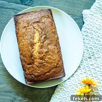 Banana Bread Made in a Bread Machine: Simple Step-by-Step Recipe 10 A loaf of bread machine banana bread on a white plate.