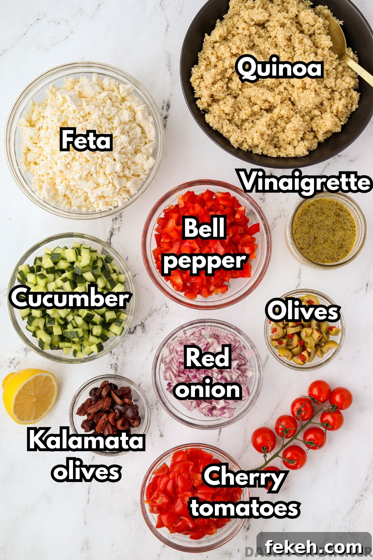 The ingredients needed to make a Greek style quinoa salad, including cucumbers, bell pepper, red onion, and olives.