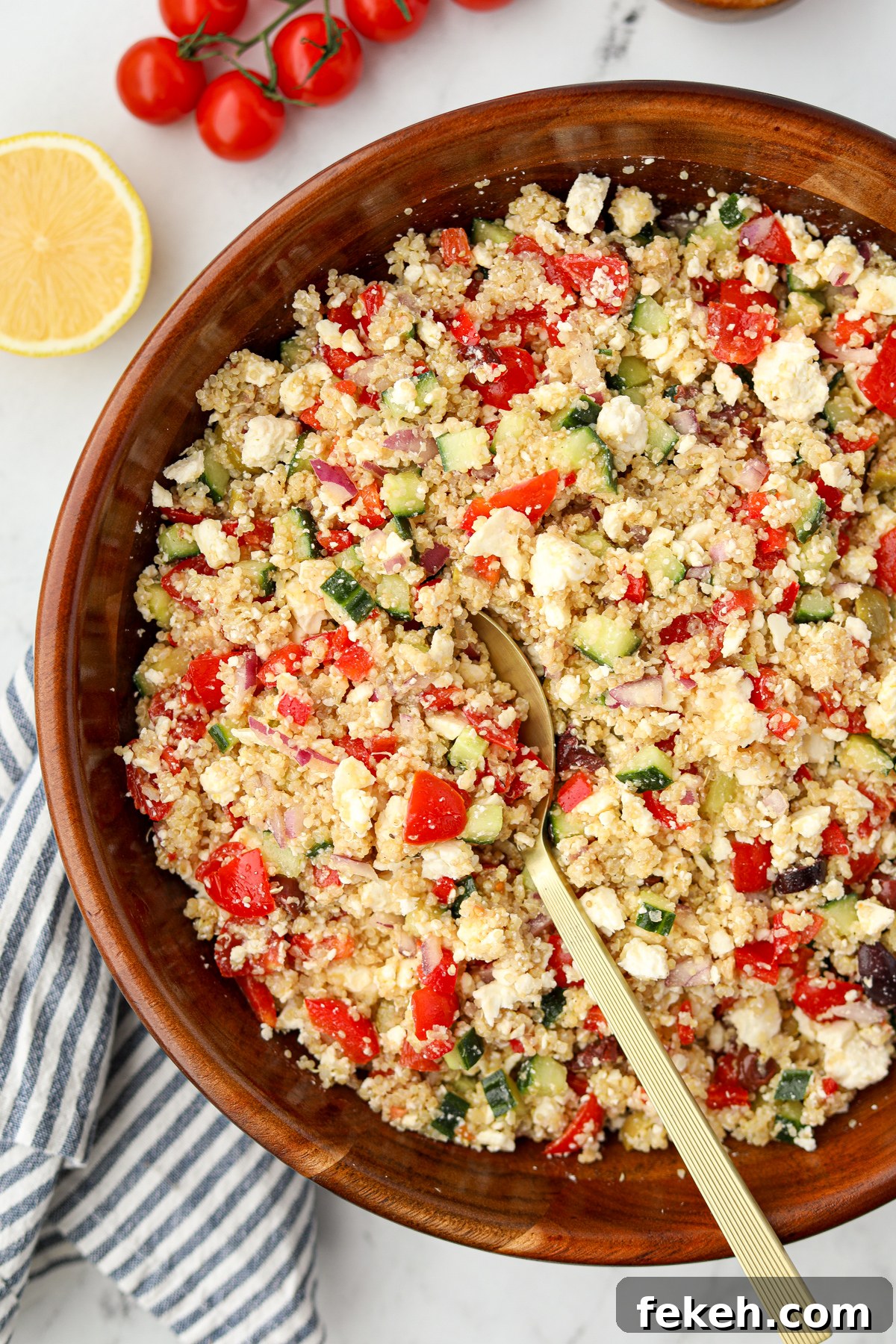 A large wooden bowl filled with quinoa salad.