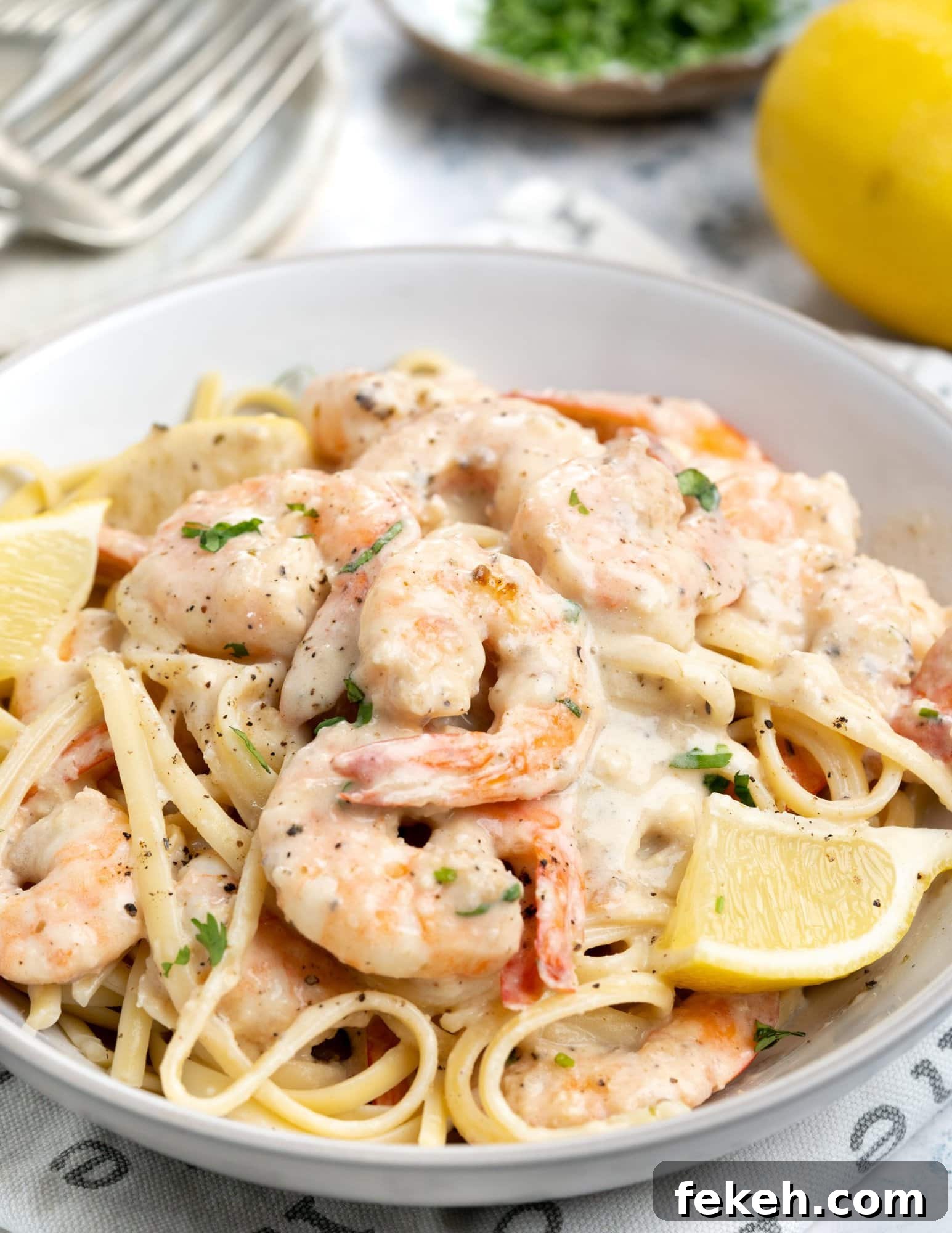 Creamy Garlic Shrimp Pasta Recipe — Quick Garlic Butter Shrimp 7 A bowl of Pasta topped with the creamy garlic Shrimp.