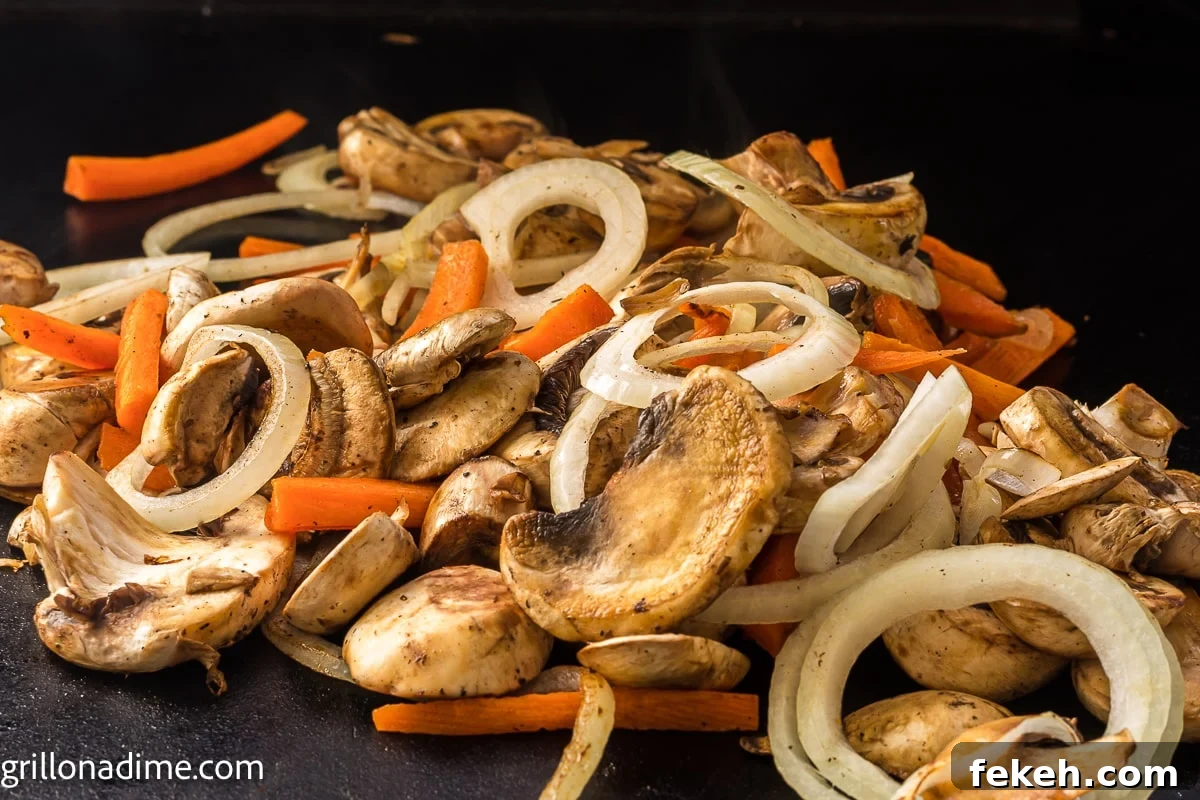 Blackstone Shrimp Yakisoba Recipe — Quick Griddle Noodle Stir-Fry 4 Slice mushrooms, slice carrots and slice onions on the griddle