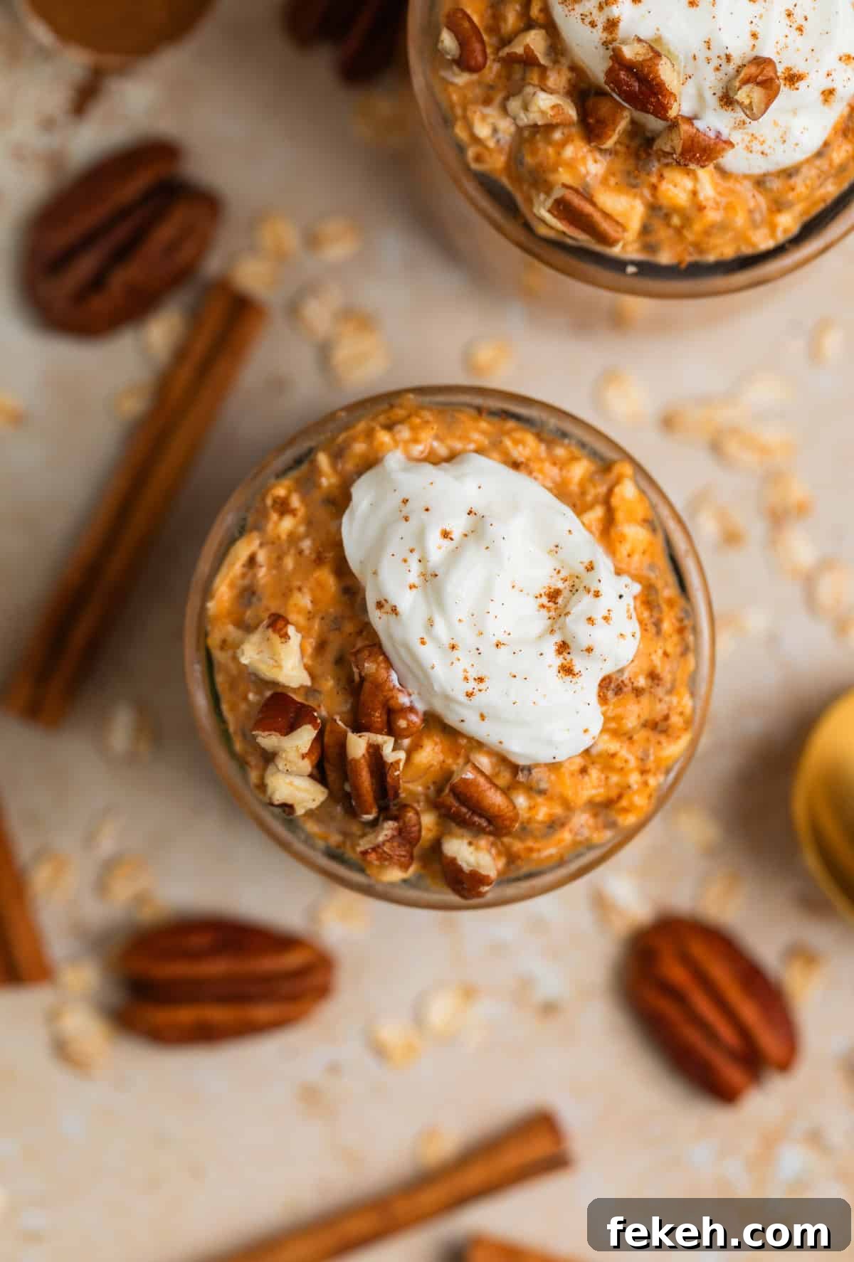 Pumpkin Pie Overnight Oats Recipe for Quick Fall Breakfast 3 Overhead view of overnight oatmeal in jars with whipped cream and cinnamon topping.