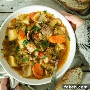 Placing a bowl of cabbage soup on a wooden table.