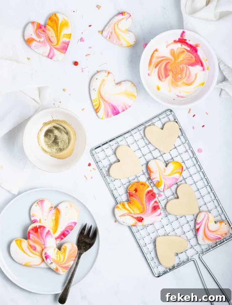 Heart-Shaped Sugar Cookies: Soft, Buttery Recipe for Any Occasion 2 iced valentine cookies on a cooling rack with a bowl of icing next to them