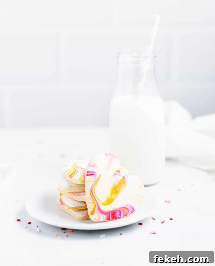 Heart-Shaped Sugar Cookies: Soft, Buttery Recipe for Any Occasion 6 stacked heart cookies next to a glass of milk