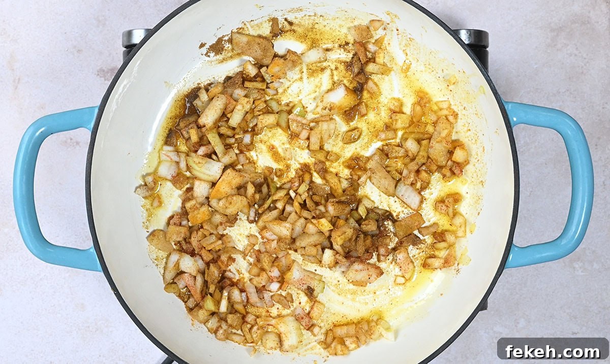 Leftover Turkey Curry Recipe for a Flavorful Dinner 5 onions cooking in a skillet with spices