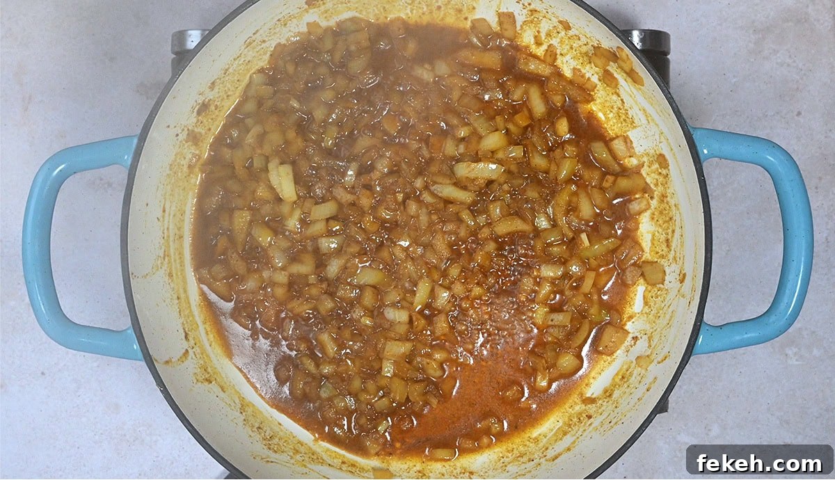 Leftover Turkey Curry Recipe for a Flavorful Dinner 6 onions cooking with spices in a casserole dish