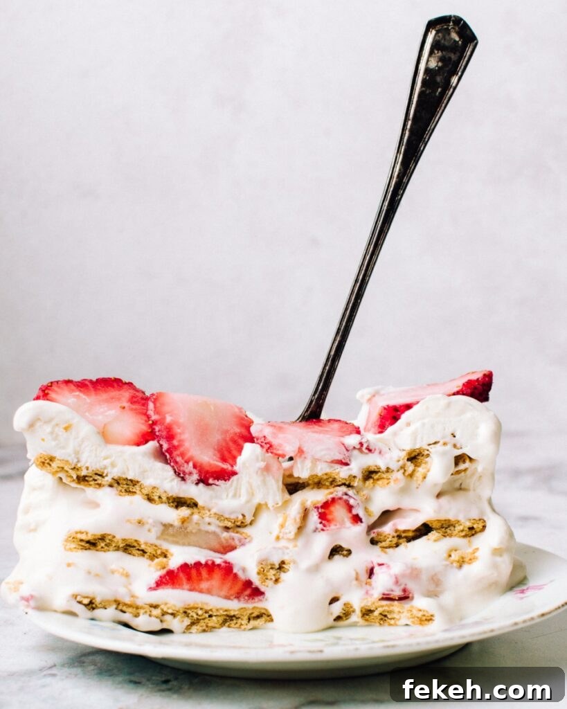 Strawberry Icebox Cake Recipe — No-Bake Summer Dessert 2 A slice of strawberry cream cheese icebox cake.