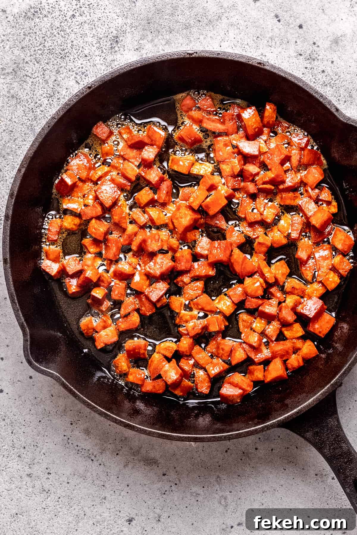 Chorizo being cooked in a pan.