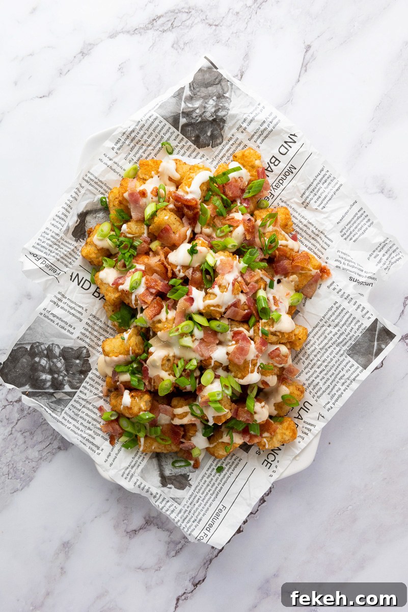 Cheesy Bacon Loaded Tater Tot Nachos (Totchos) 8 Green onions are sprinkled on top.