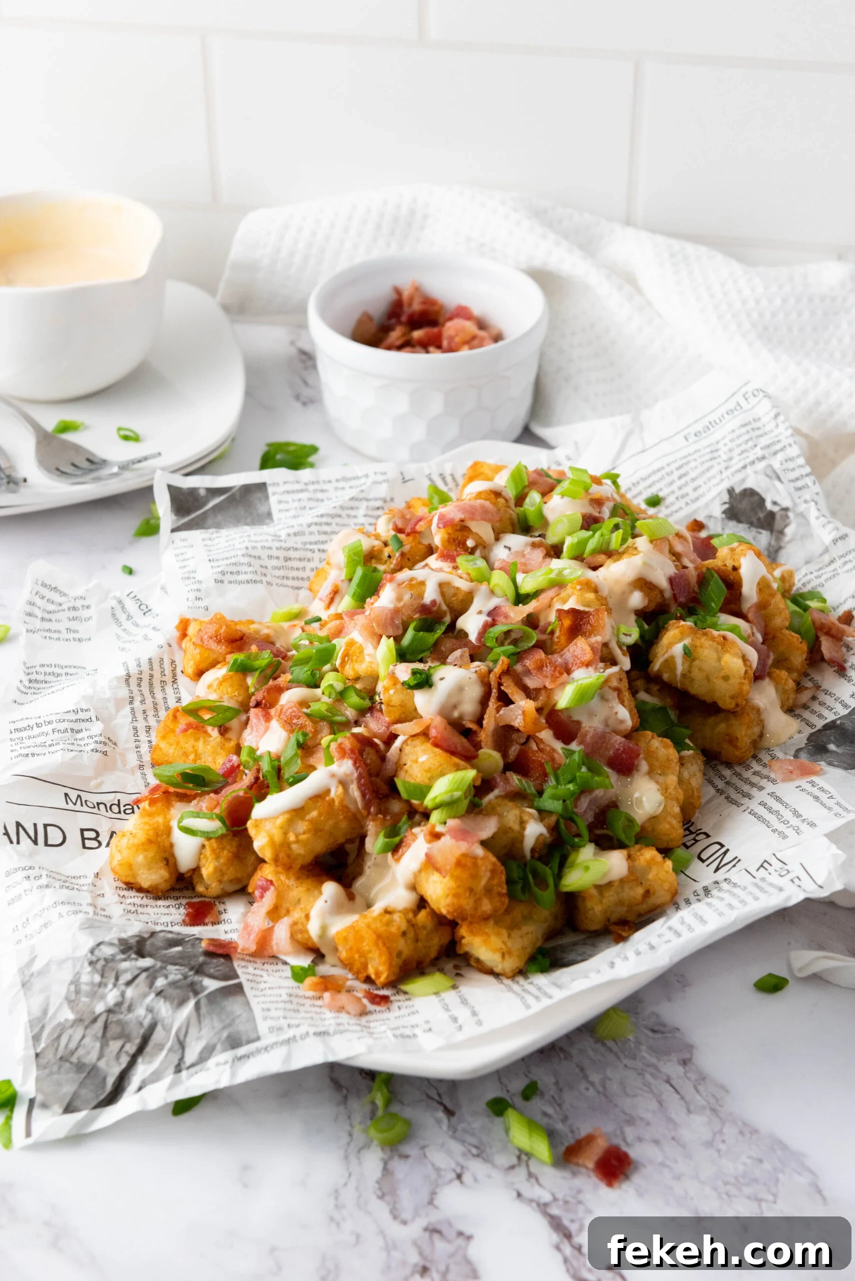 Cheesy Bacon Loaded Tater Tot Nachos (Totchos) 9 Side view of tater tots served on a plate for a party.
