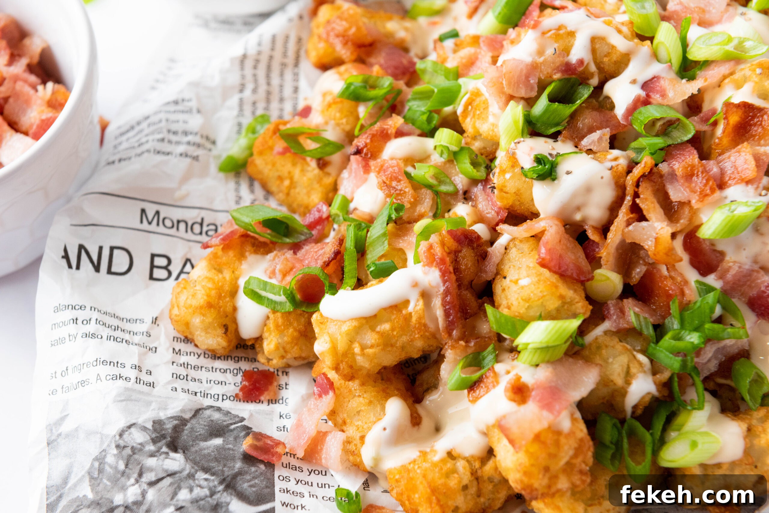 Cheesy Bacon Loaded Tater Tot Nachos (Totchos) 3 Loaded tater tots served on a plate.
