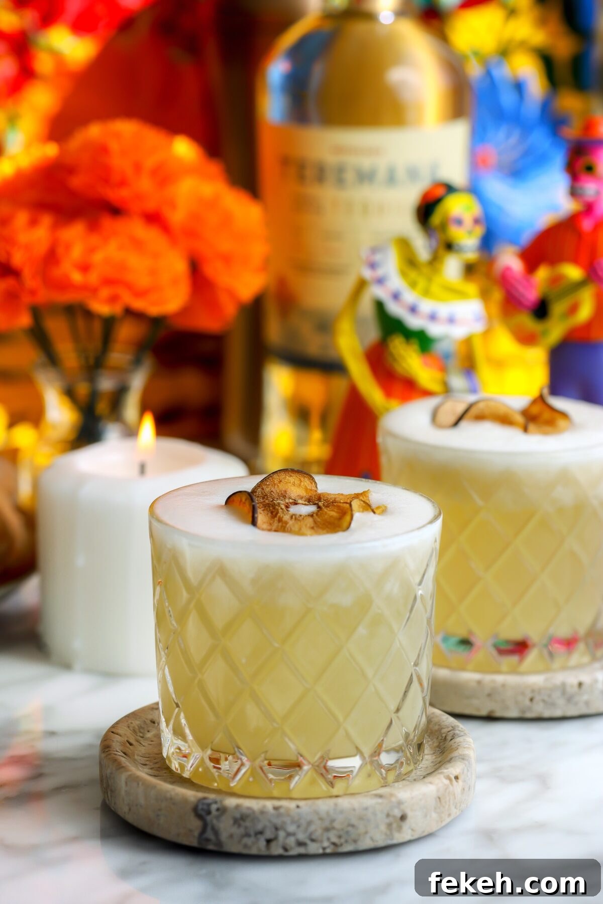 A beautiful Pear tequila sour with a foam top, garnished with a dried spiced pear.
