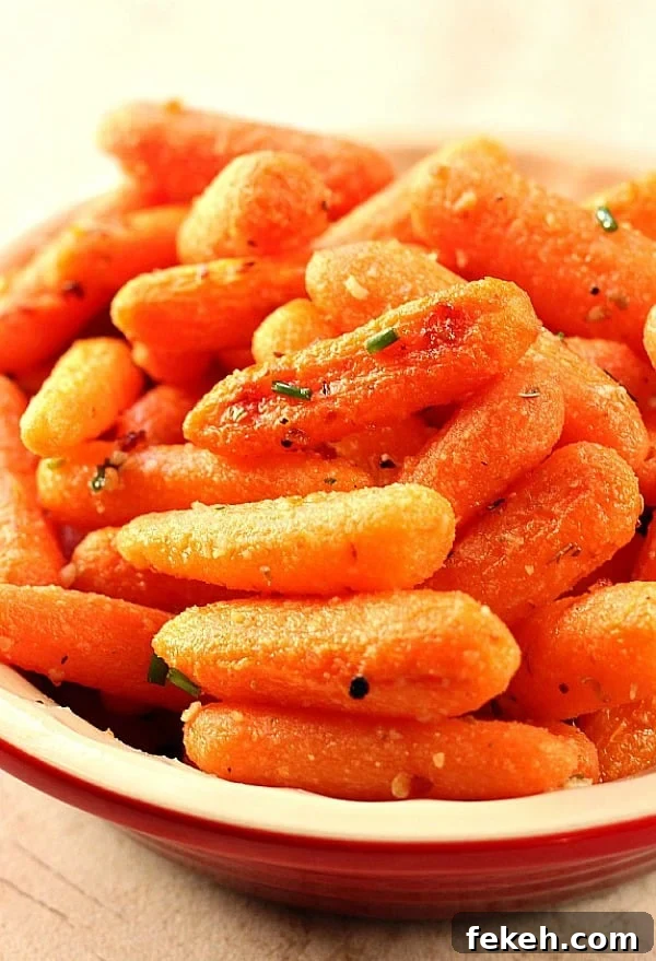 Easy Garlic Parmesan Roasted Baby Carrots - roasting carrots brings out their sweetness and rich flavor! Roasted Baby Carrots in a bowl.