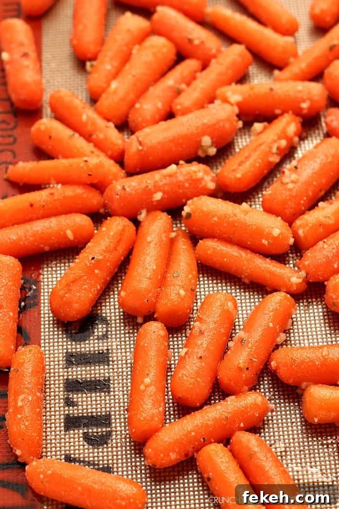 Easy Garlic Parmesan Roasted Baby Carrots Easy Garlic Parmesan Roasted Baby Carrots in a baking tray.