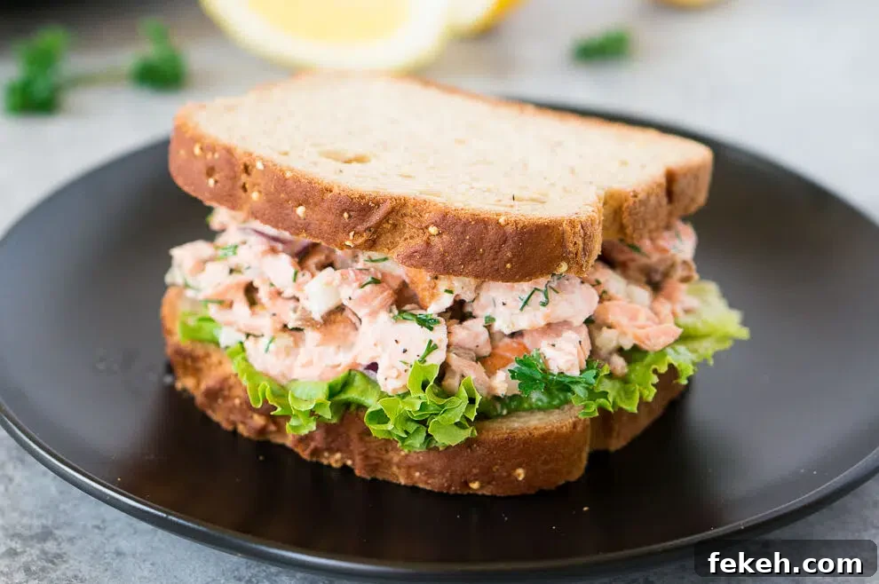 Quick Salmon Salad Recipe for Light, Flavorful Meals 10 salmon salad sandwich on a black plate