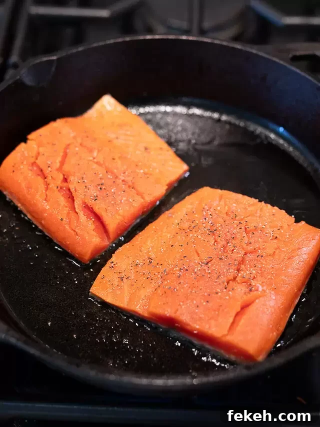 Quick Salmon Salad Recipe for Light, Flavorful Meals 4 cooking salmon in a skillet on the cooktop