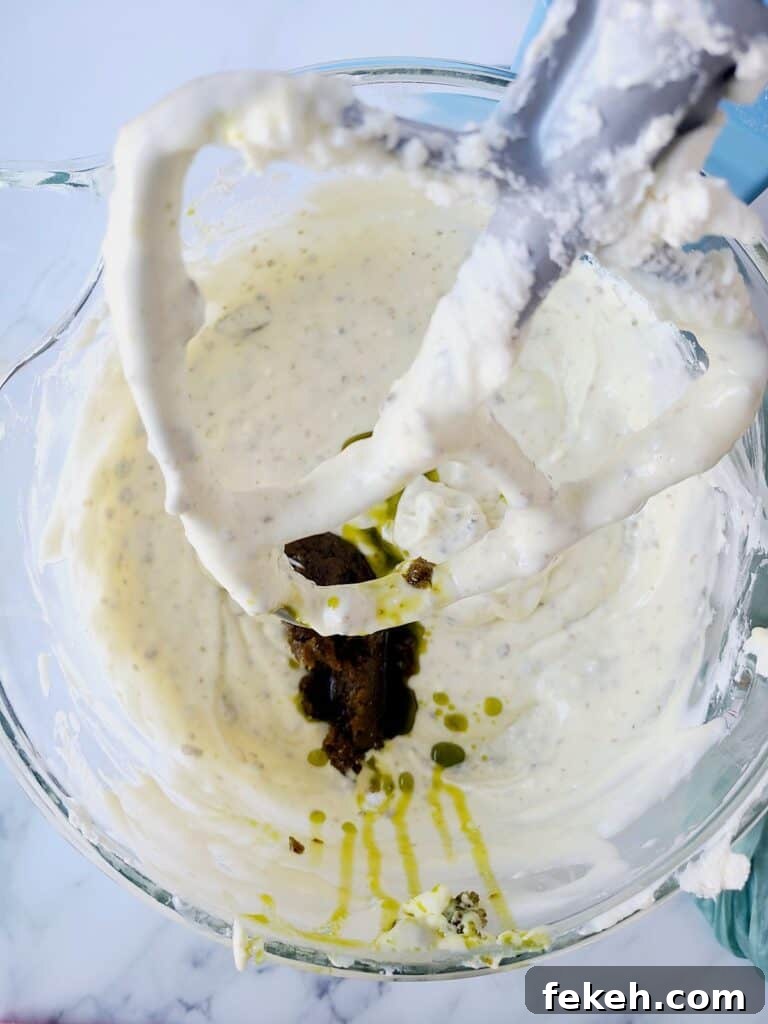 Creamy Pistachio Cheesecake with Real Pistachios and Homemade Paste 11 Adding pistachio paste into cheesecake batter