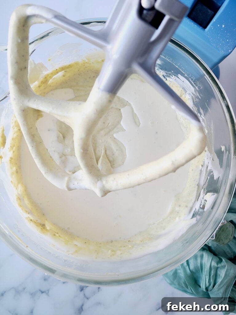 Creamy Pistachio Cheesecake with Real Pistachios and Homemade Paste 13 Adding heavy cream into cheesecake batter