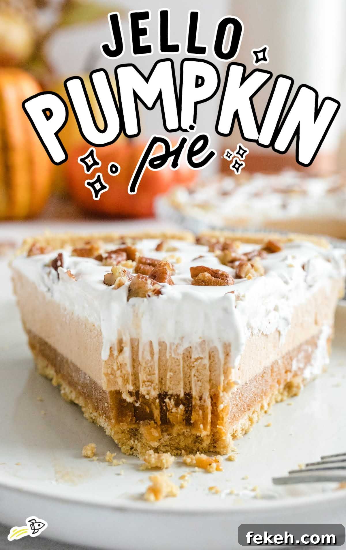 No-Bake Pumpkin Pie with Jello Filling 2 Close-up of a slice of layered pumpkin spice Jello pie with whipped topping and chopped pecans on top, showing creamy layers and graham cracker crust.