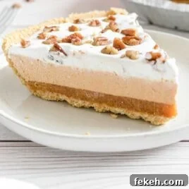 No-Bake Pumpkin Pie with Jello Filling 9 close up shot of a slice of Layered Pumpkin Spice Jello Pie topped with pecans on a plate