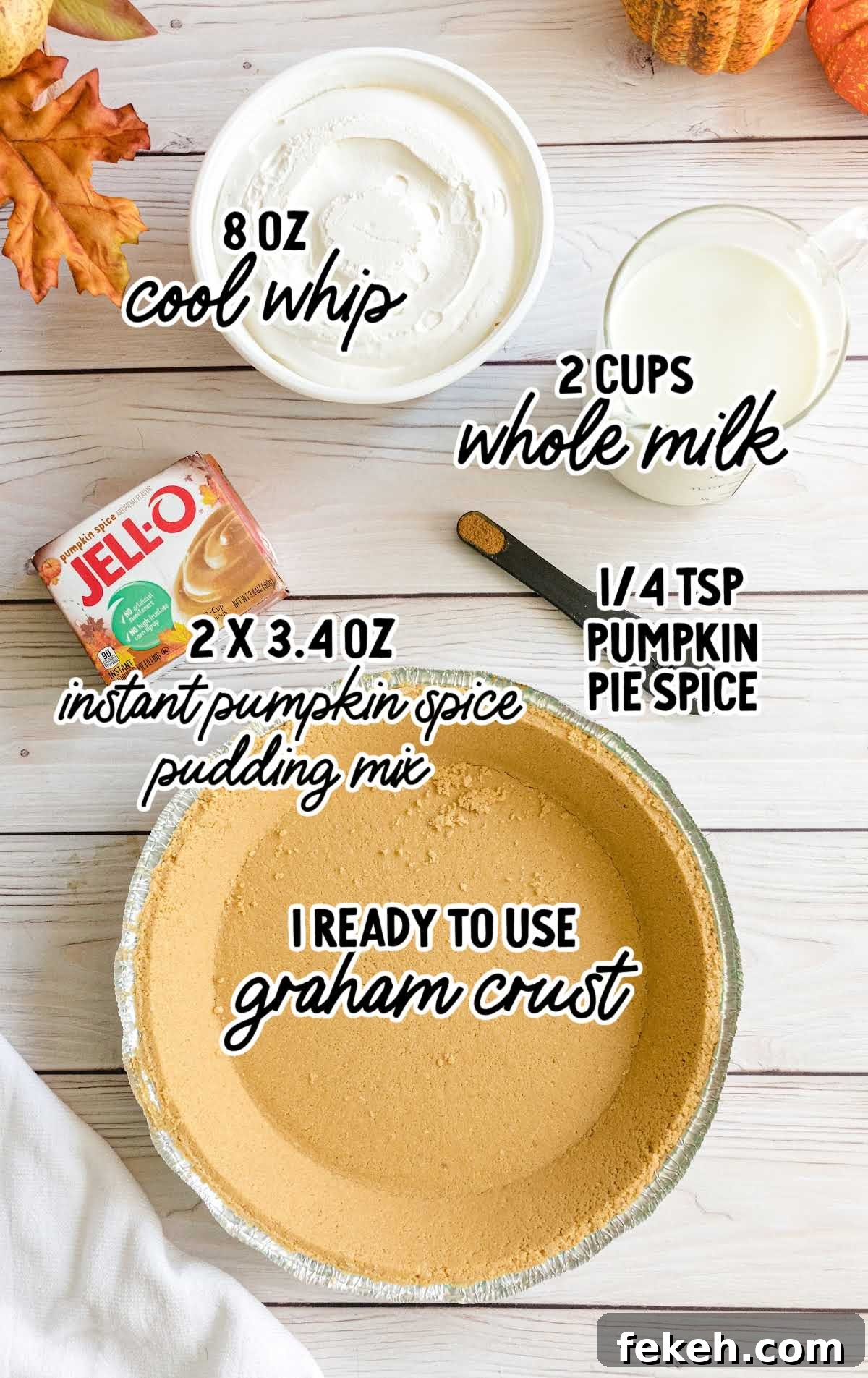 No-Bake Pumpkin Pie with Jello Filling 3 Ingredients for layered pumpkin spice Jello pie arranged on a marble surface, including pumpkin puree, gelatin, and whipped topping.