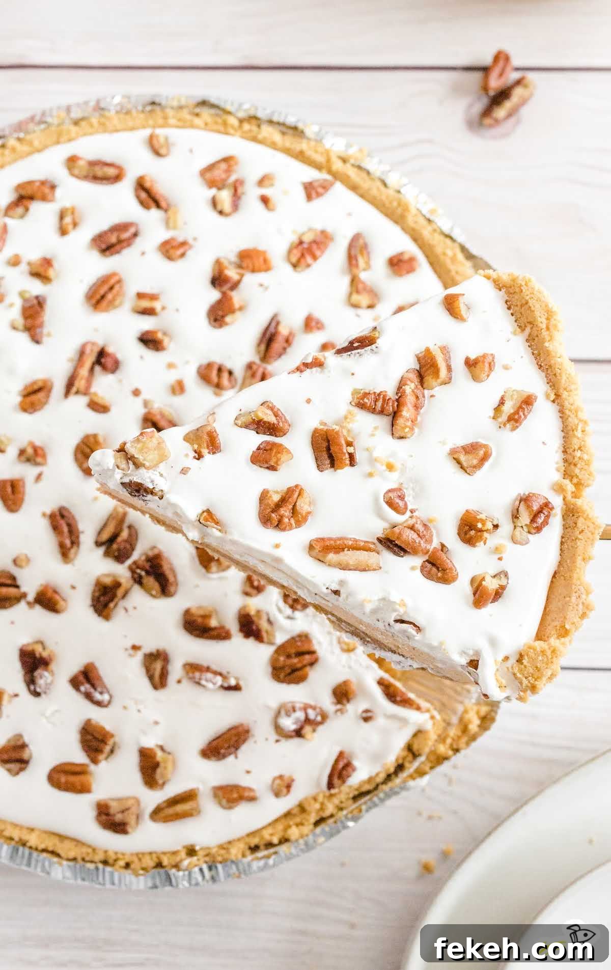 No-Bake Pumpkin Pie with Jello Filling 6 Side angle of a slice of layered pumpkin spice Jello pie showing its creamy orange layers and whipped topping.