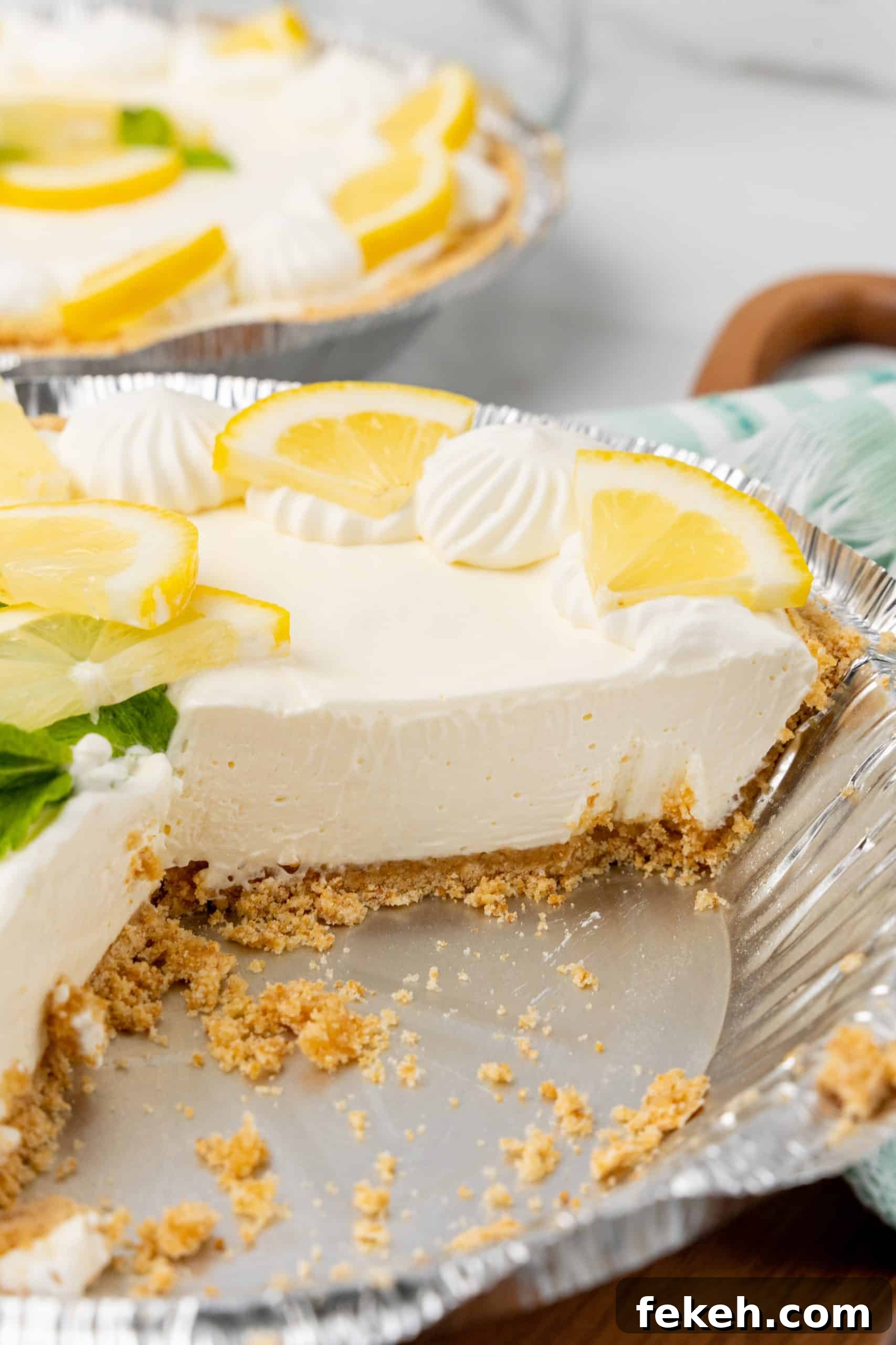 No-Bake Lemonade Cream Pie Recipe: Refreshing Summer Dessert 11 a creamy no bake lemonade cheesecake in an aluminum pie dish