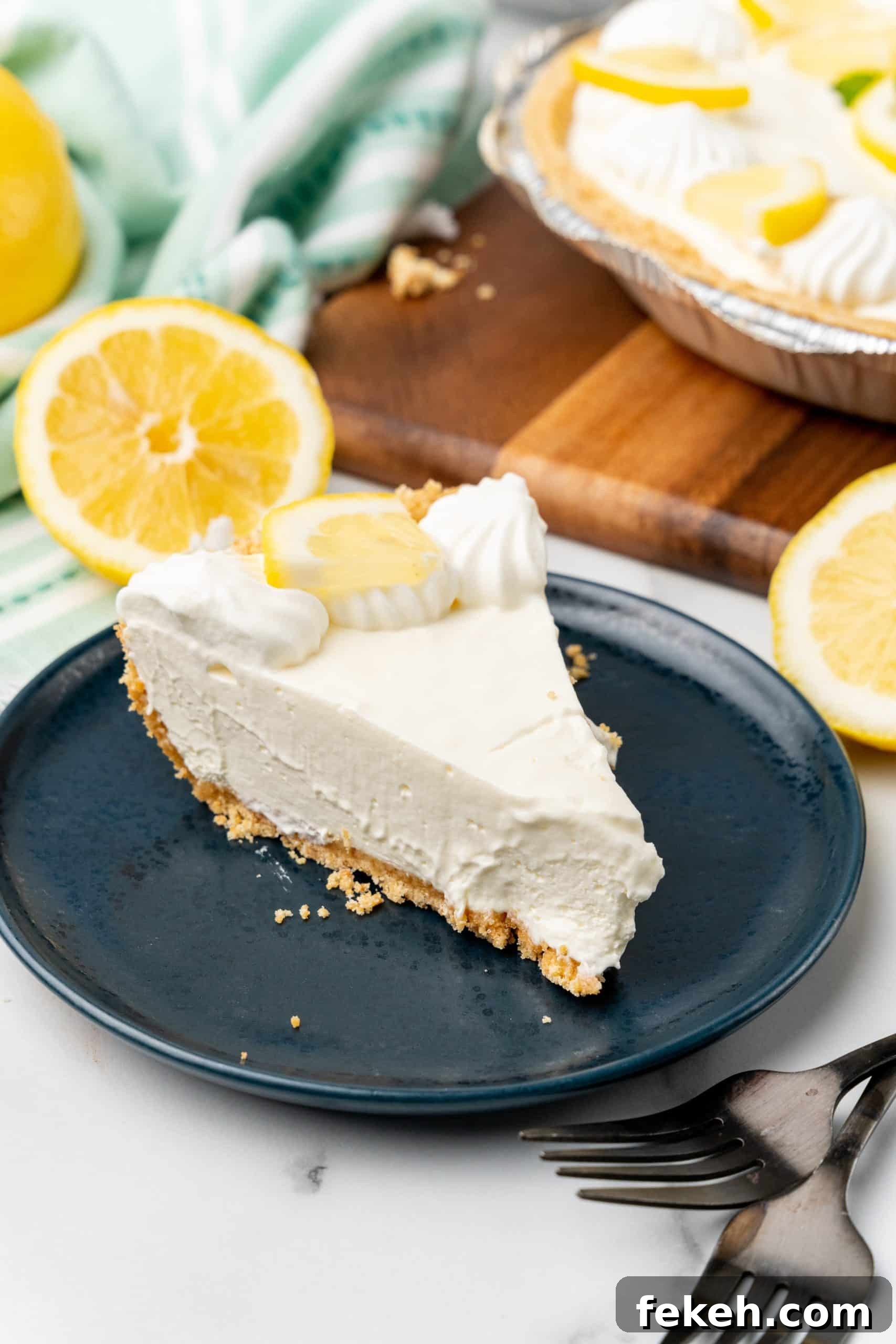 No-Bake Lemonade Cream Pie Recipe: Refreshing Summer Dessert 12 a slice of no bake lemonade cheesecake on a small blue plate