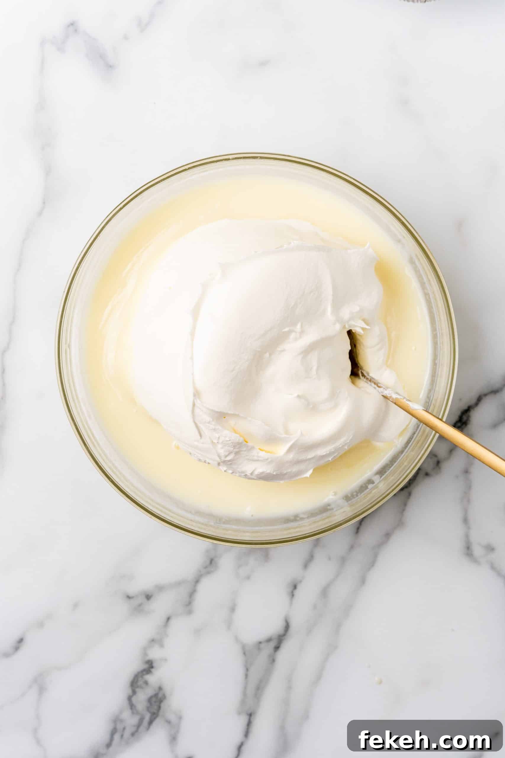 No-Bake Lemonade Cream Pie Recipe: Refreshing Summer Dessert 7 cool whip lemonade mixture in a glass mixing bowl