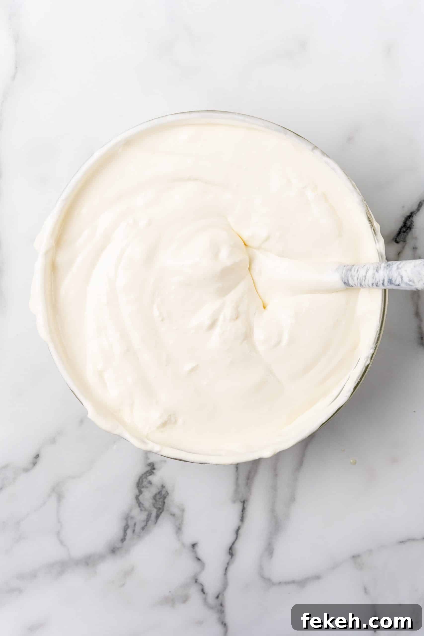 No-Bake Lemonade Cream Pie Recipe: Refreshing Summer Dessert 8 a creamy lemonade mixture in a glass mixing bowl