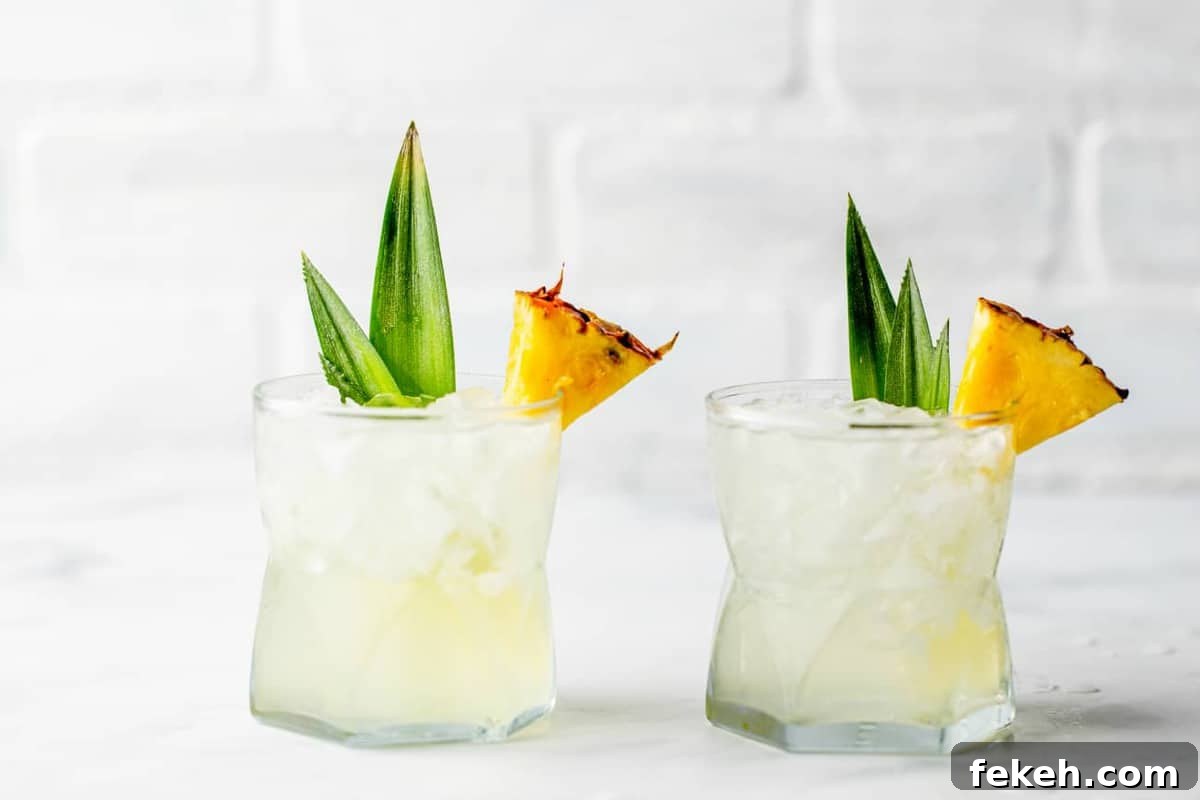 How to Make Stoli Doli: Puerto Rican Coconut Rum Dessert Recipe 3 Two glasses of Stoli Doli on the rocks, garnished with pineapple