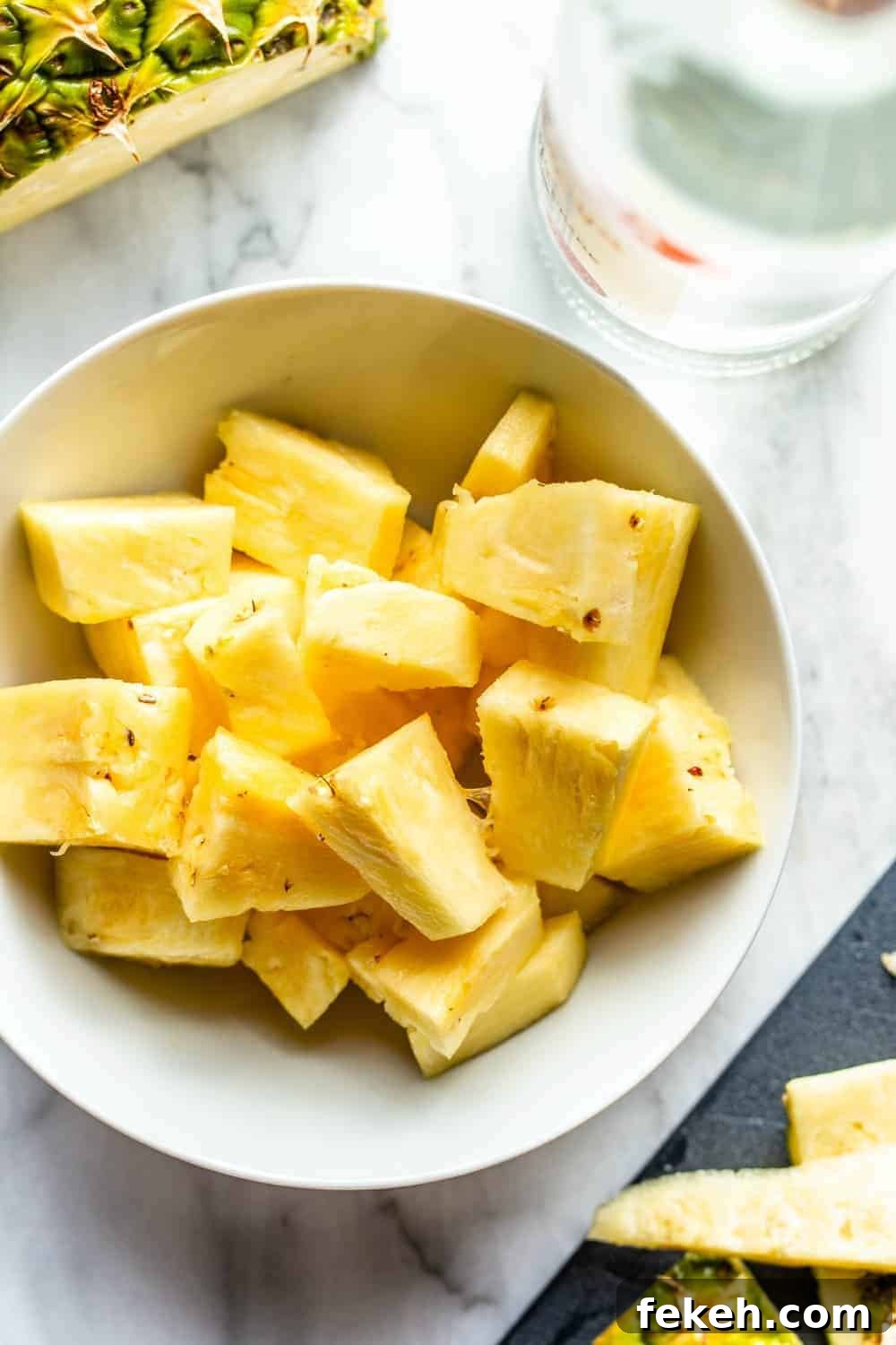 How to Make Stoli Doli: Puerto Rican Coconut Rum Dessert Recipe 5 Diced pineapple in a white bowl
