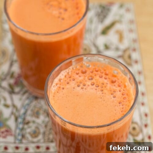Carrot Apple Ginger Detox Juice Recipe 4 Two glasses of fresh carrot apple ginger juice.