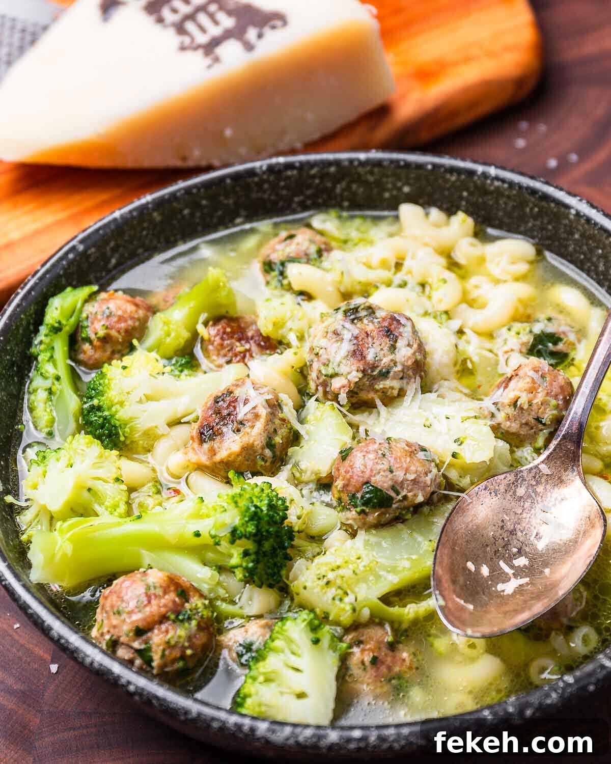 Macaroni and Broccoli with Mini Meatballs Recipe 2 Black bowl with macaroni, broccoli, and tiny meatballs.