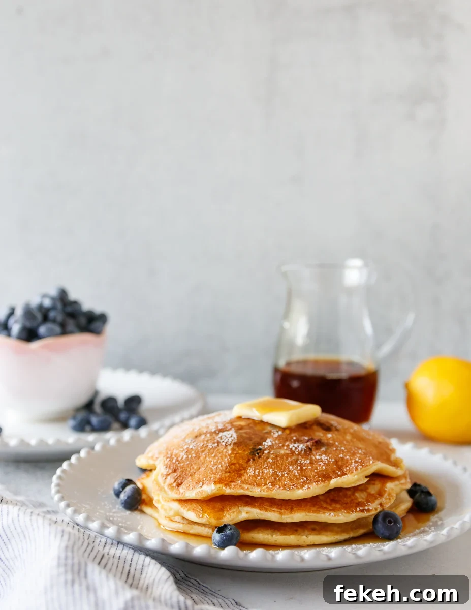 Lemon Blueberry Pancakes Recipe with Fluffy Buttermilk Stack 2 plated lemon blueberry pancakes