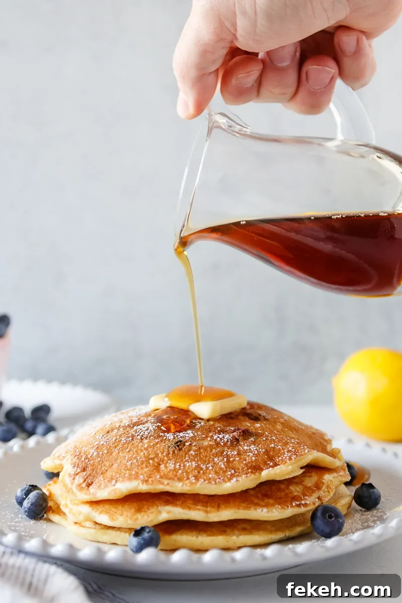 Lemon Blueberry Pancakes Recipe with Fluffy Buttermilk Stack 6 pouring syrup on pancakes