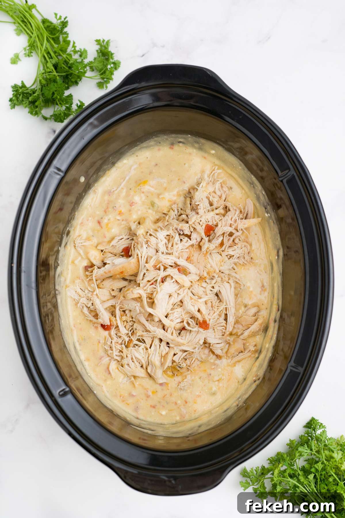 Chicken and cheese added back to the slow cooker.