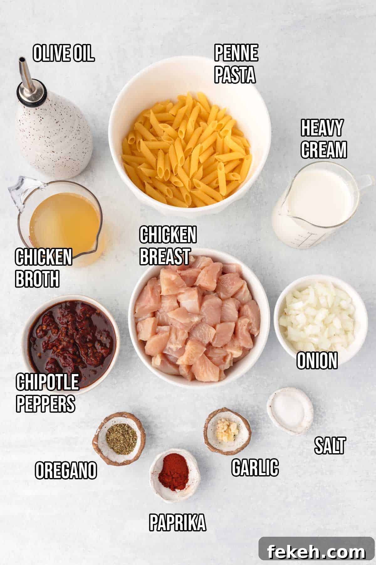 Creamy Chipotle Chicken Pasta Recipe — Smoky Sauce & Quick Dinner 3 Spicy chipotle chicken pasta ingredients: chicken breasts cut into bite sized pieces, penne pasta, olive oil, minced garlic, diced onion, chipotle peppers in adobo sauce, chicken broth, heavy cream, paprika, dried oregano, and kosher salt.