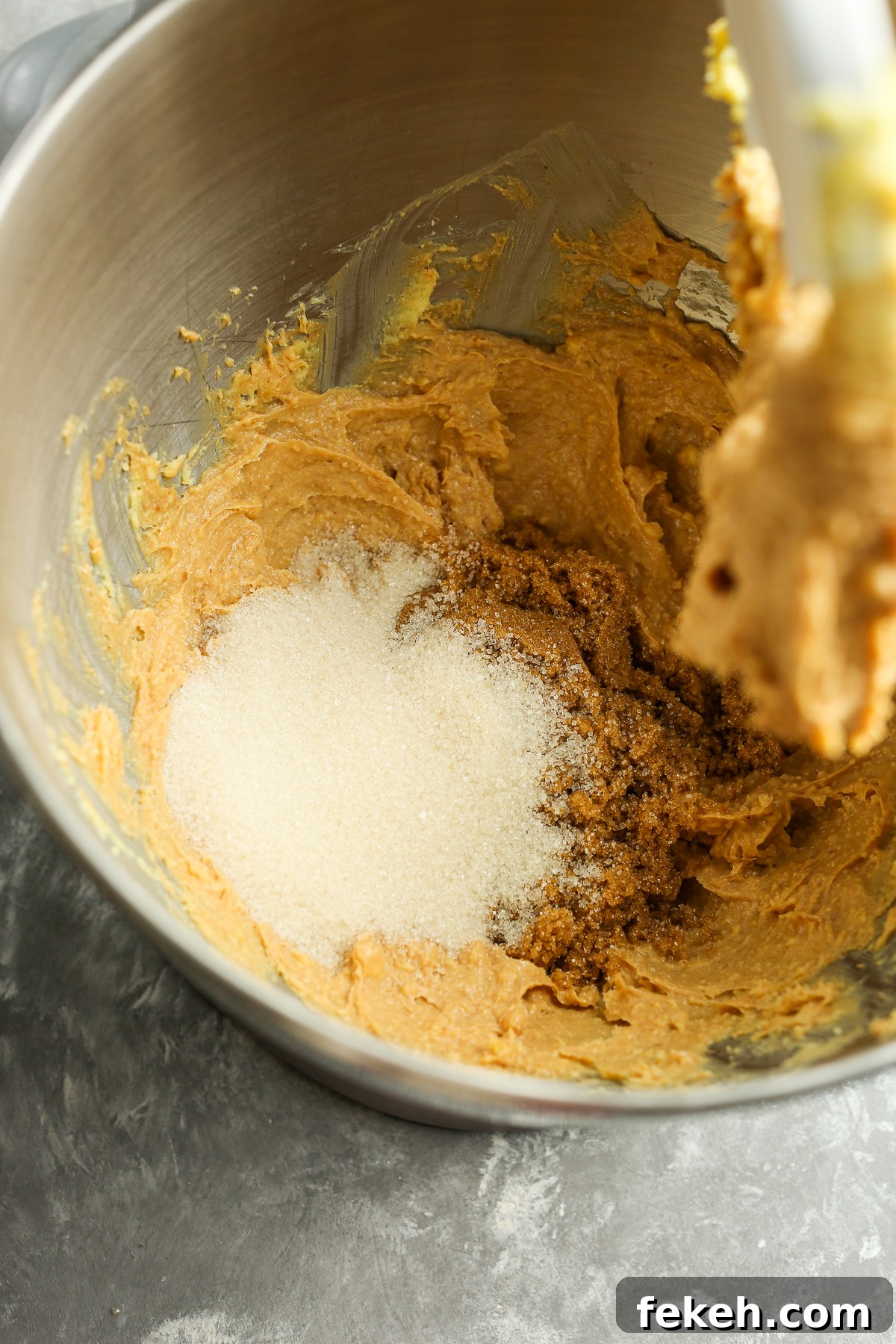 adding sugar to cookie mixture