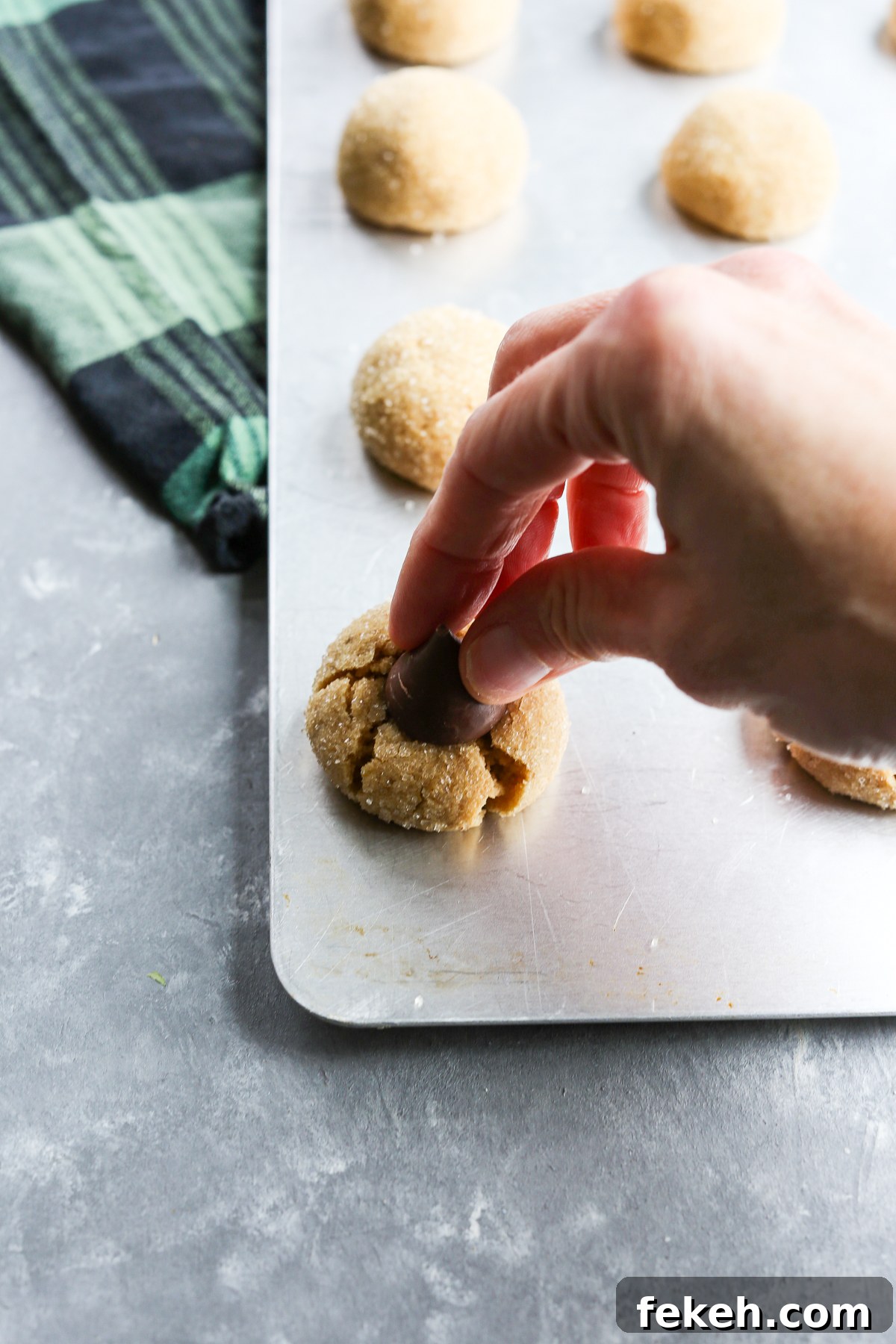 putting a kiss on the top of gluten free peanut butter blossoms