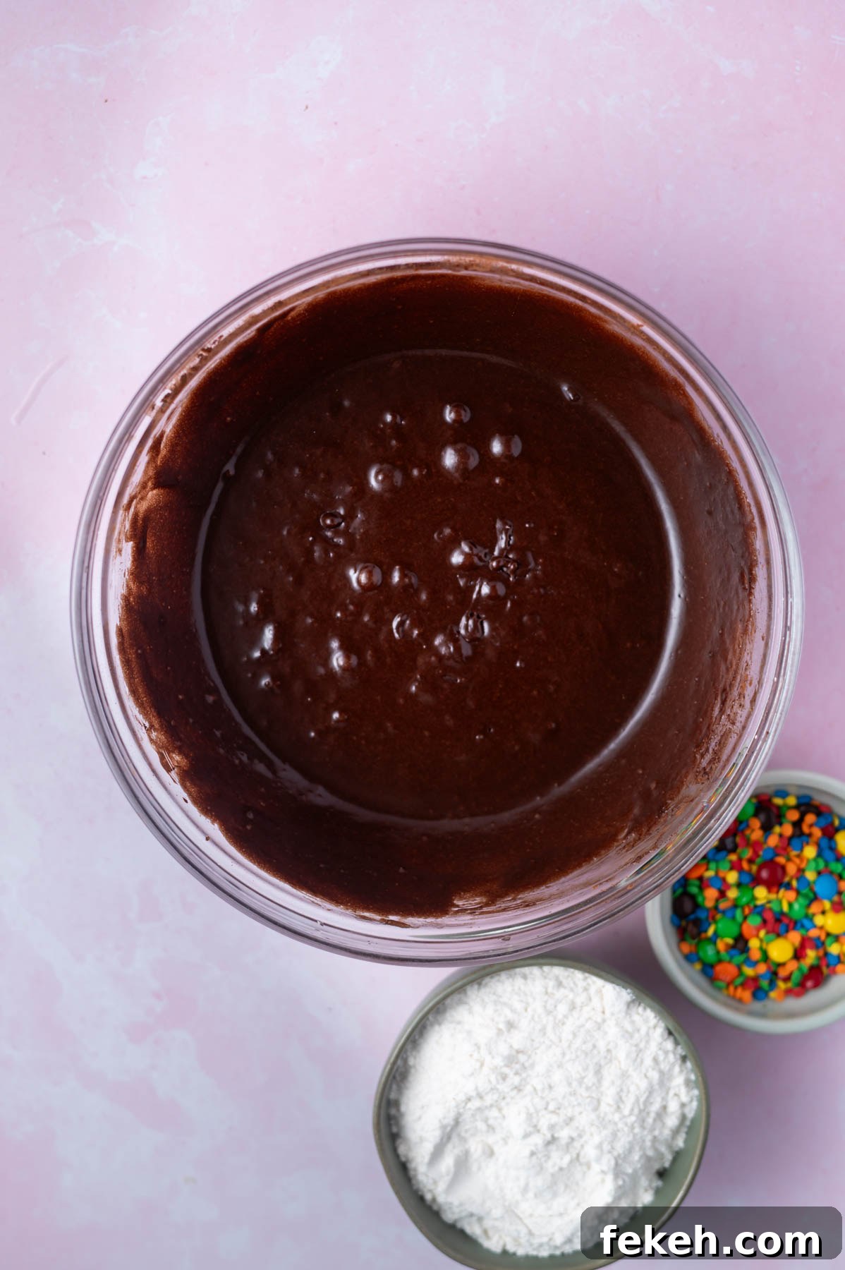 Fudgy Cosmic Brownie Cookie Recipe for Gooey Chocolate Lovers 7 cocoa powder whisked into cookie dough in a bowl