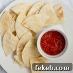 Easy Homemade Tortilla Chips on white plate with salsa on side